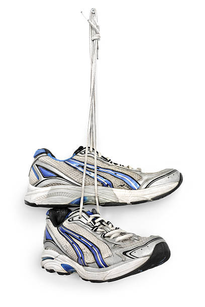 istock Sneakers hanging from a nail on white background 185061664