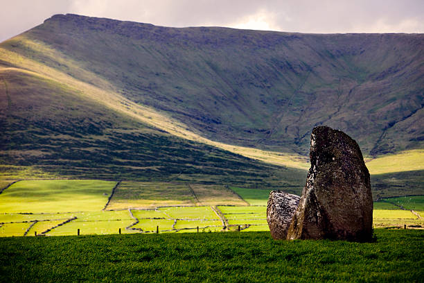 Beautiful Irish landscape with standing stones on foreground.