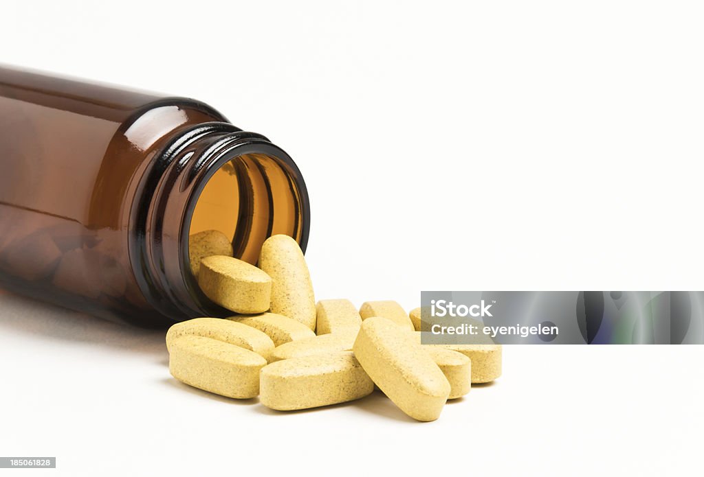 Vitamin "Vitamin pills spilling from an open bottle, not isolated" Nutritional Supplement Stock Photo