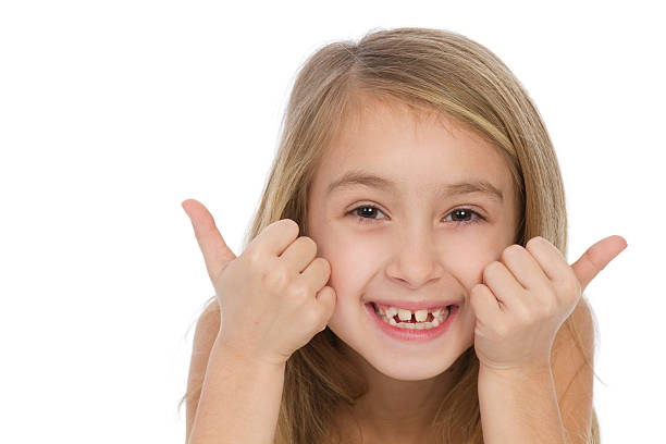 istock smiling girl gesturing thumbs up 185061967