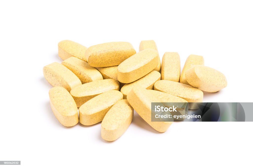 Yellow vitamin pills isolated on a white background A bunch of multivitamin pills, not isolated Pill Stock Photo
