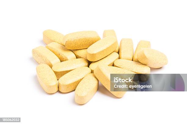Yellow Vitamin Pills Isolated On A White Background Stock Photo - Download Image Now