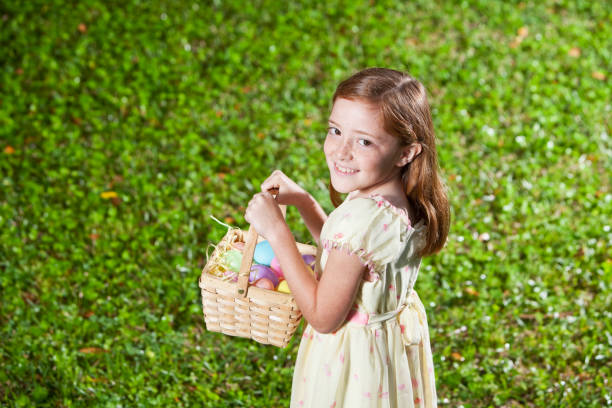istock Little girl holding Easter egg basket 185062385