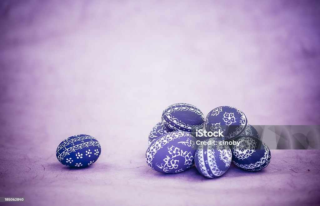 Pile of Easter Eggs pile of easter eggs on purple background - is design easter eggs homemade Animal Egg Stock Photo