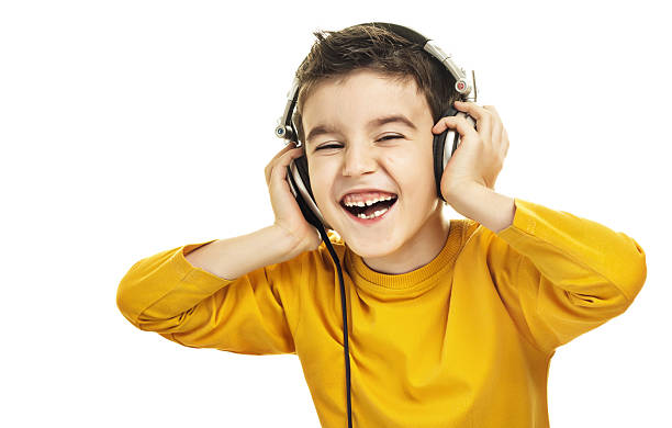 Little child in headphones isolated on white.