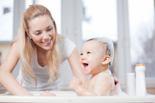 Young beautiful mother take a bath her sweet baby