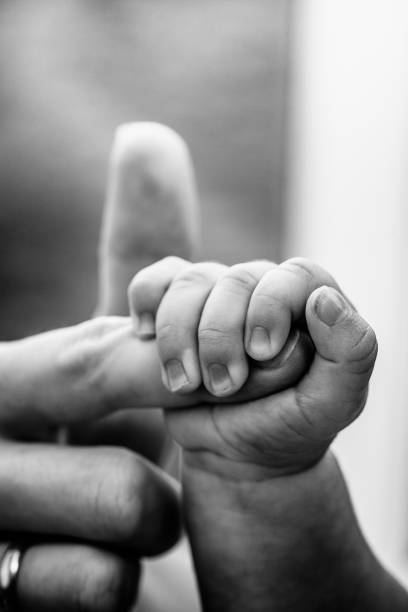 istock Baby Hand Holding Mothers Finger 185063146