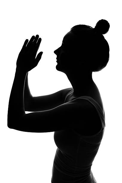 istock Silhouette of a woman praying 185063486