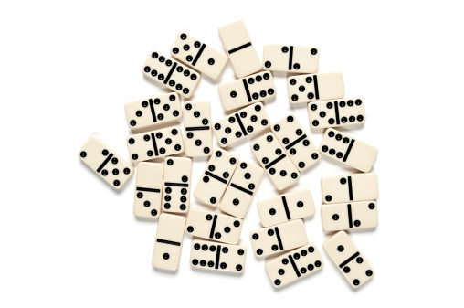 Ivory domino scattered and isolated on white background.