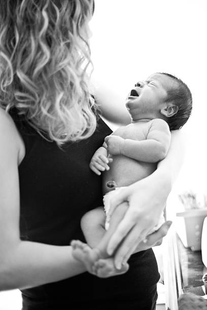 istock Black & White Image of Mother Holding Her Crying Newborn 185063807
