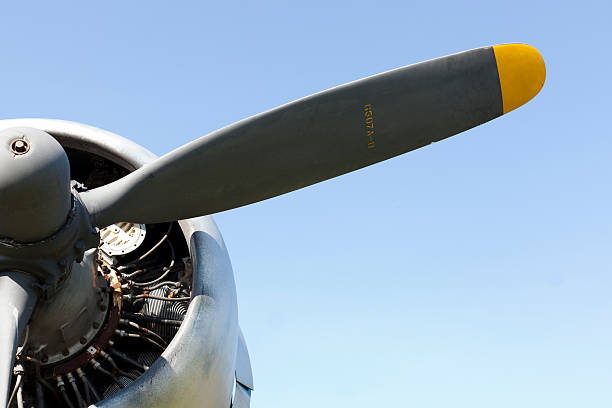 istock Old military aircraft propeller engine against a clear blue sky 185063916