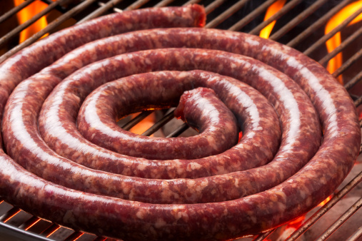 Raw boerewors (South African beef sausage) just placed on the braai (barbeque) to cook. Traditionally South AfricanSimilar images