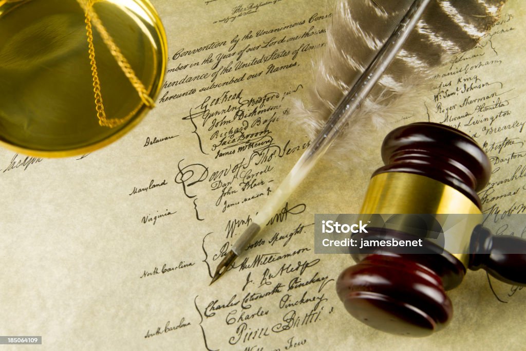 Legal Constitution Background "US Constitution Lower Signatures Part Replica arrangement with judge courtroom gavel, turkey feather quill pen and a golden scale below. Shot with dual studio softboxes and EOS 7D." Backgrounds Stock Photo