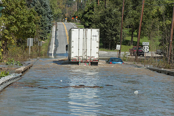 Truck Going Through Deep Flood Water Over Highway stock photo