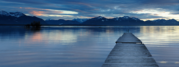 Wooden Jetty into a Mountain Lake at Sunset