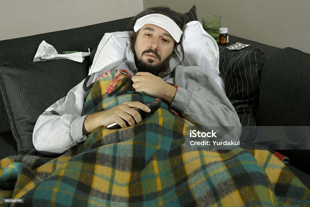 sick man lyning on the couch sick man lyning on the couch with remote control in handsimilar images: Beard Stock Photo