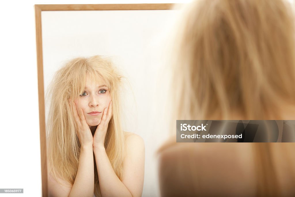 Woman with Bad Hair A young woman looking upset and fed up with her hair.  One Woman Only Stock Photo