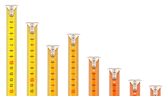 Eight tape measures, all diferently extended and colored from yellow to red according to their declining length / height. Can be used as separate graphic elements or as a conceptual image representing a falling bar graph. (Adobe RGB)