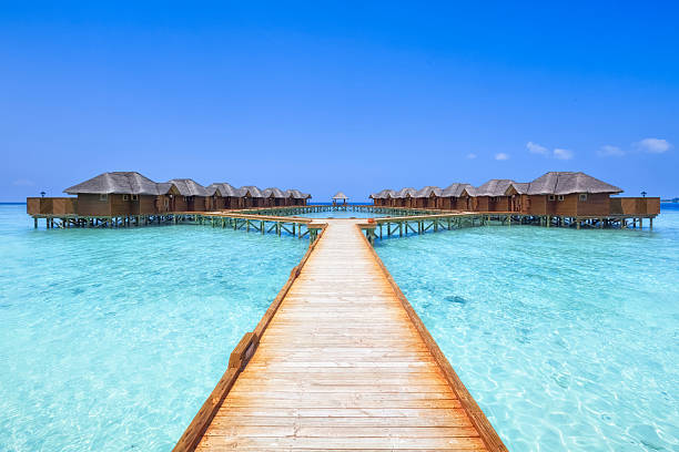 Overwater Bungalows Boardwalk overwater bungalows boardwalk of the Maldives hut stock pictures, royalty-free photos & images