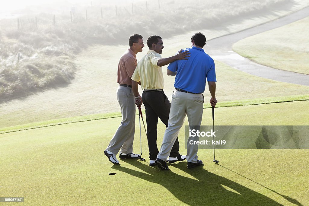 Maschio golfisti legame - Foto stock royalty-free di Golf