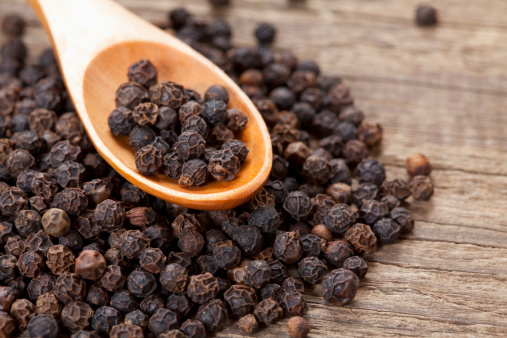 close up of black peppercorn in wooden teaspoon; Adobe RGB color space; see other similar images: