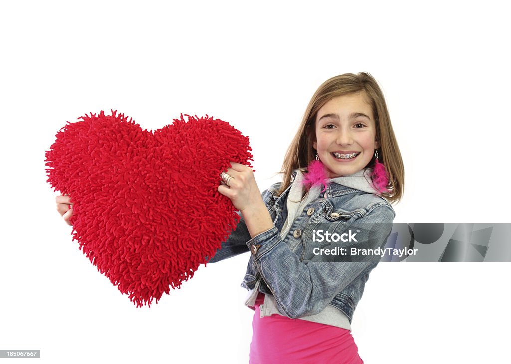 Valentine love girl isolated on white holding out a big red heart Cheerful Stock Photo