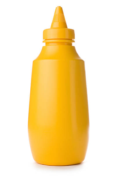 Close-up of yellow mustard bottle on a white background Plastic squeezey yellow mustard bottle isolated on a white background mustard stock pictures, royalty-free photos & images