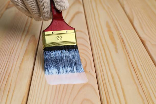 istock Man varnishing wooden surface with brush, closeup. Space for text 1850678716