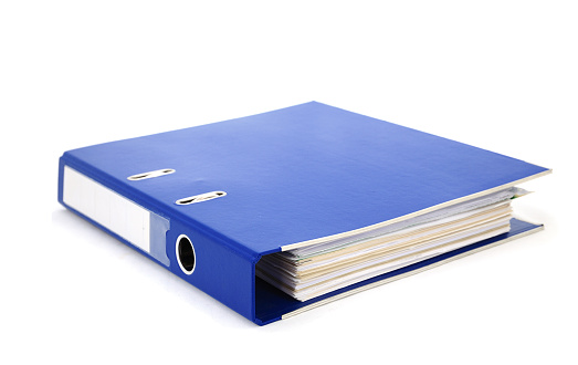 Blue office binder filled with paper on white background