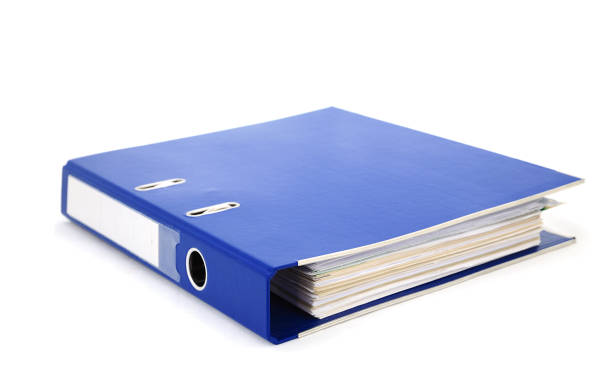 Blue office binder filled with paper on white background stock photo