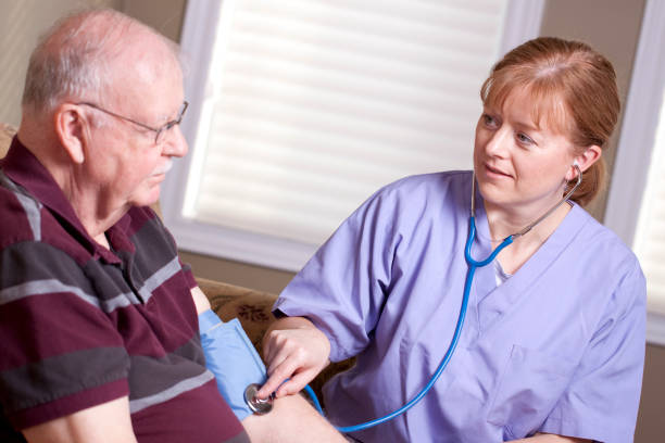 istock Elderly man and caregiver - stethescope 185067965