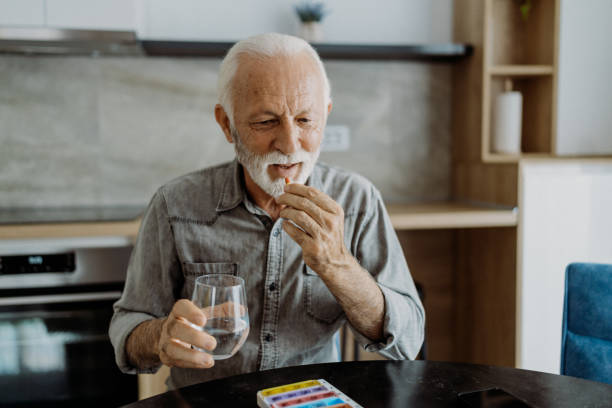 istock Senior man taking his medicine 1850680923