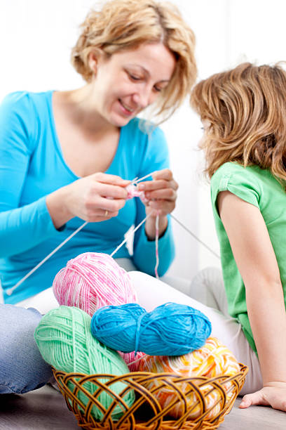 istock Mother and children knitting at home. 185068193