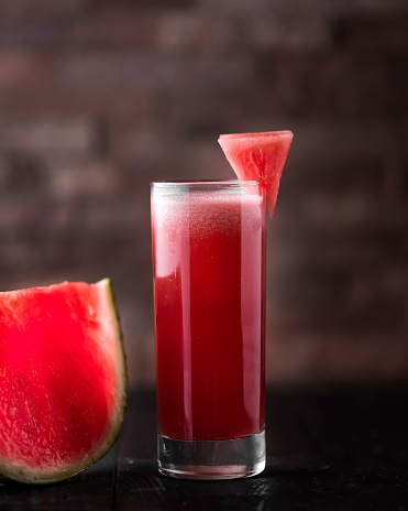 Fresh Watermelon Juice served in glass isolated on wooden table side view of arabic healthy fruit juice