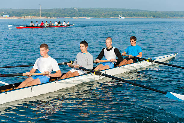 quatro sentado equipe de remo com par de remos - rowboat sport rowing team sports race imagens e fotografias de stock