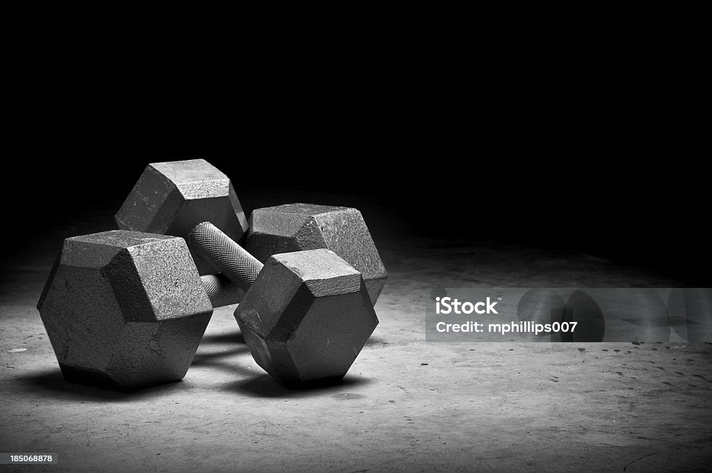 Weight lifting Dumbbells isolated on grunge surface. Please see my portfolio for other sport related images. Weights Stock Photo