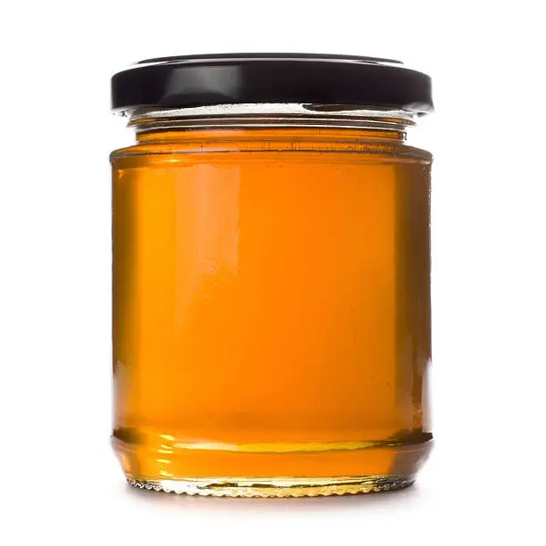 Jar of honey isolated on a white background