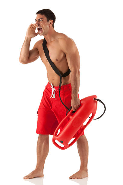 männliche rettungsschwimmer tragen sie es und rufen - isolated on white full length red protection stock-fotos und bilder