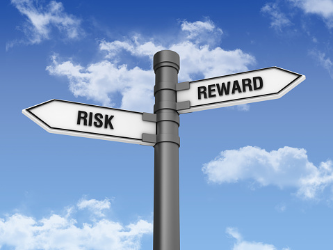 Directional Sign with RISK REWARDS Words and Sky