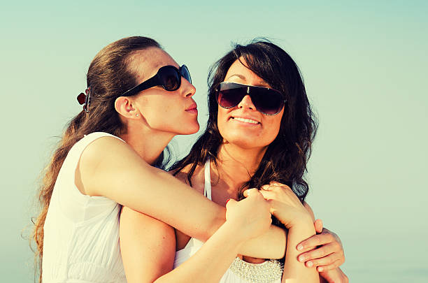 istock Lesbian couple relax embracing at sea 185070116