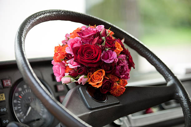 istock Bouquet of flowers on steering wheel 185070495