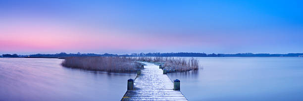 istock Boardwalk on a lake at dawn in winter, The Netherlands 185070724