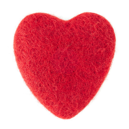 Close up of a red felt heart shape on a white background