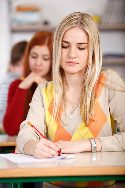 istock Group of college students doing an exam 185070847