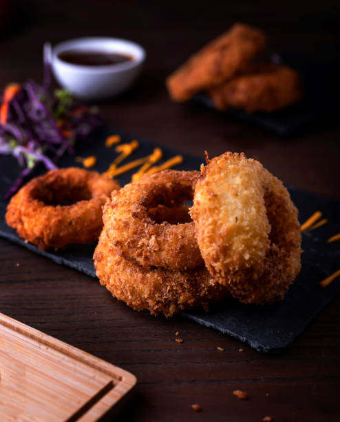 istock Deep Fried Golden Crispy Onion Rings with dip served in dish isolated on wooden table side view of arabic food 1850708873