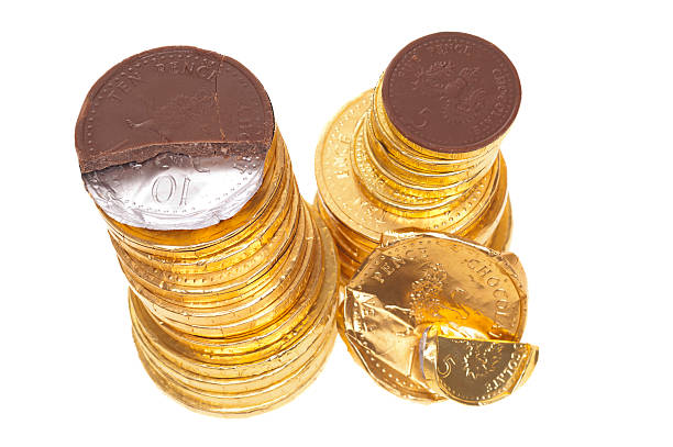 istock Chocolate money coins stacked on white 185070943