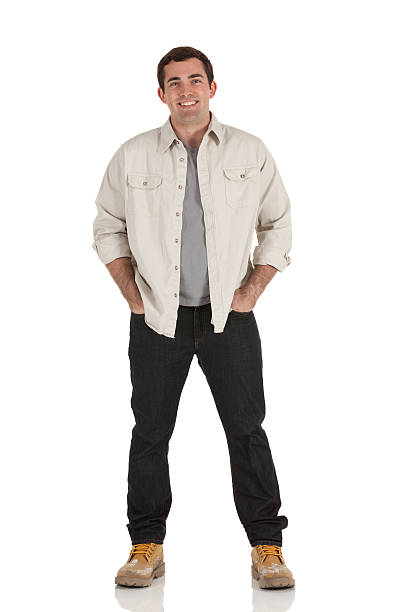 istock Happy man standing with his hands in pockets 185071089