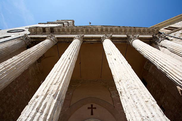 Temple Of Minerva In Assisi The columns of the Temple of Minerva in Assisi. Umbria, Italy. umbria architecture assisi corinthian stock pictures, royalty-free photos & images