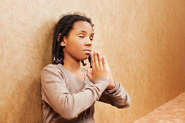 istock Young girl praying. 185071629