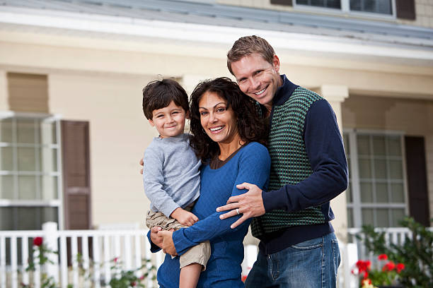 istock Family standing in front of house 185071662